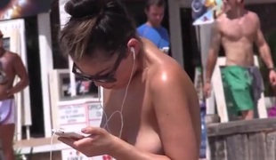 Cute topless beach girl has wonderful natural breasts