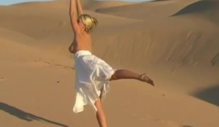 Bendy busty teen honey shows off natural assets on sand dunes