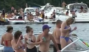 Bikini-clad babe with a great body flashing her big tits at beachgoers